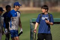 FILE - Los Angeles Dodgers' Shohei Ohtani walks with interpreter Ippei Mizuhara at batting prac ...