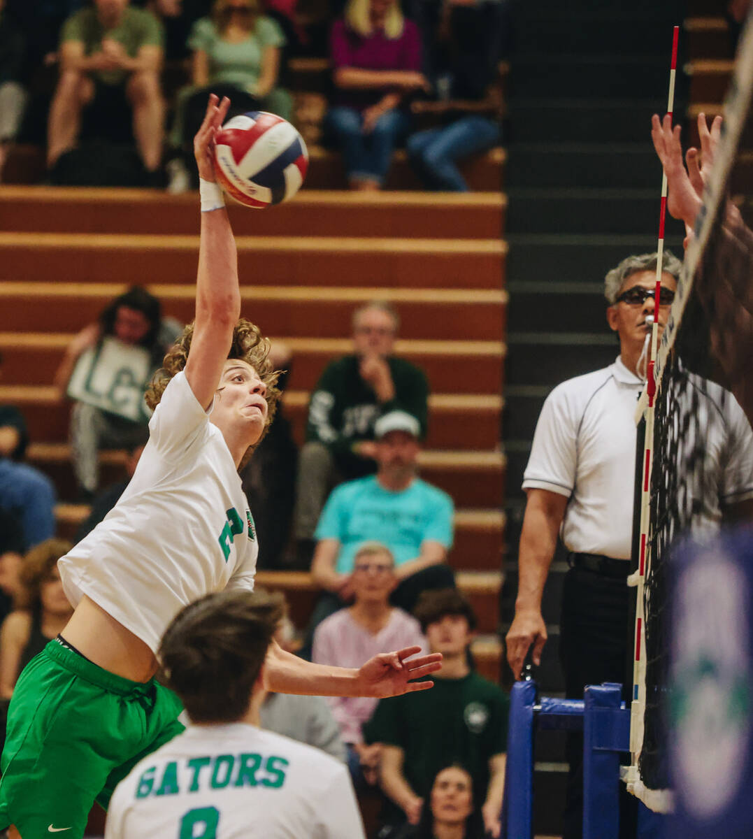 Green Valley outside hitter Brock Barney hits the ball over the net during a volleyball match b ...