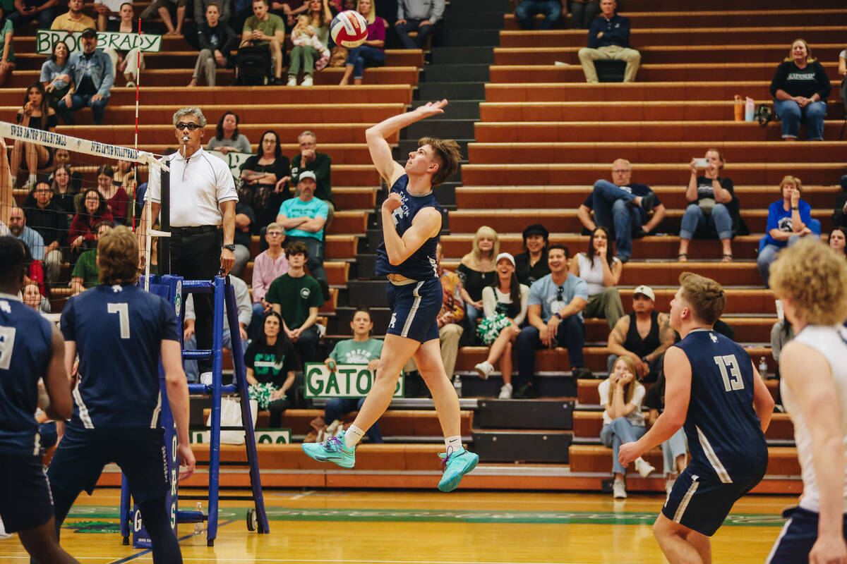 Shadow Ridge middle blocker Jace Bishop forces the ball back over the net during a volleyball m ...