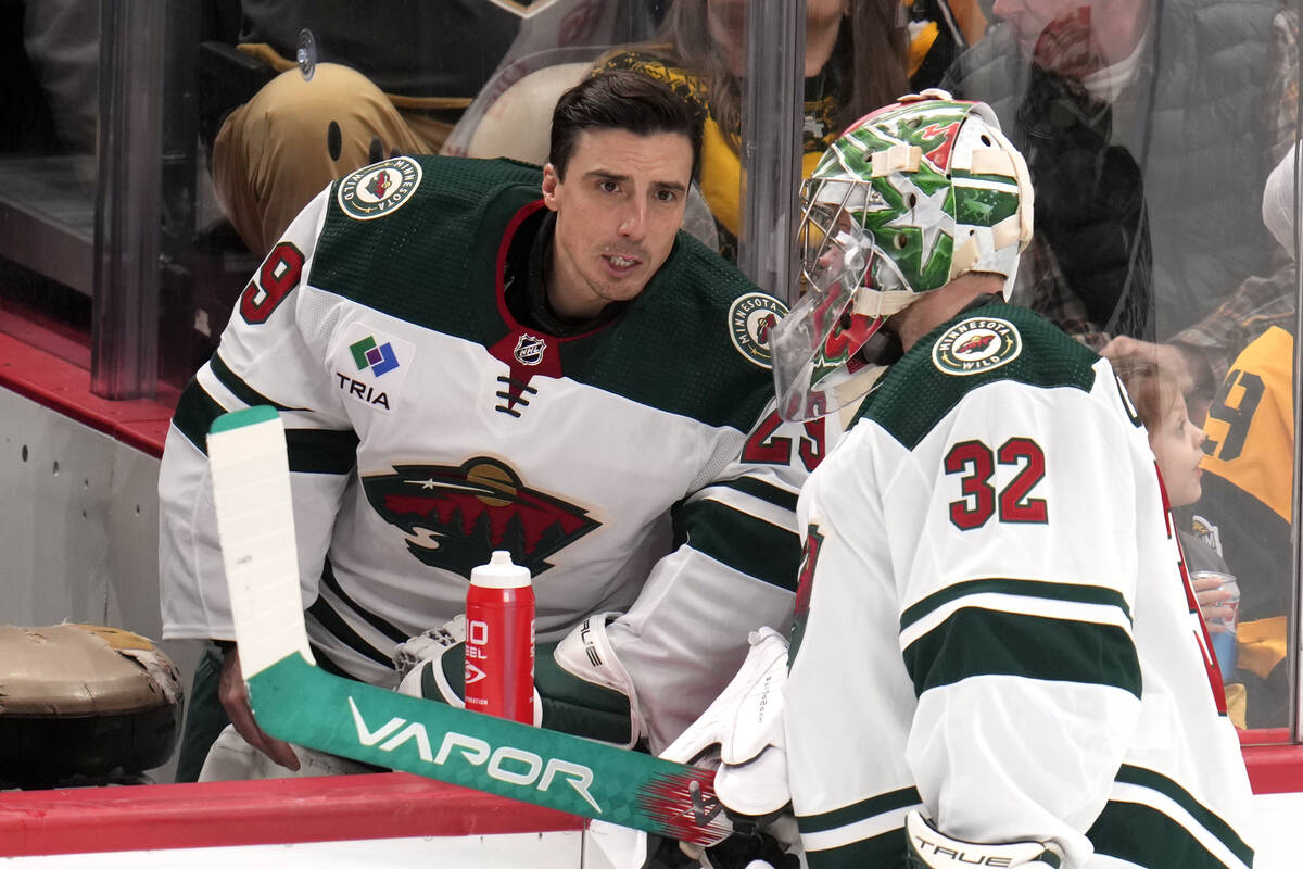 Minnesota Wild goaltender Filip Gustavsson (32) talks with Marc-Andre Fleury during a timeout i ...