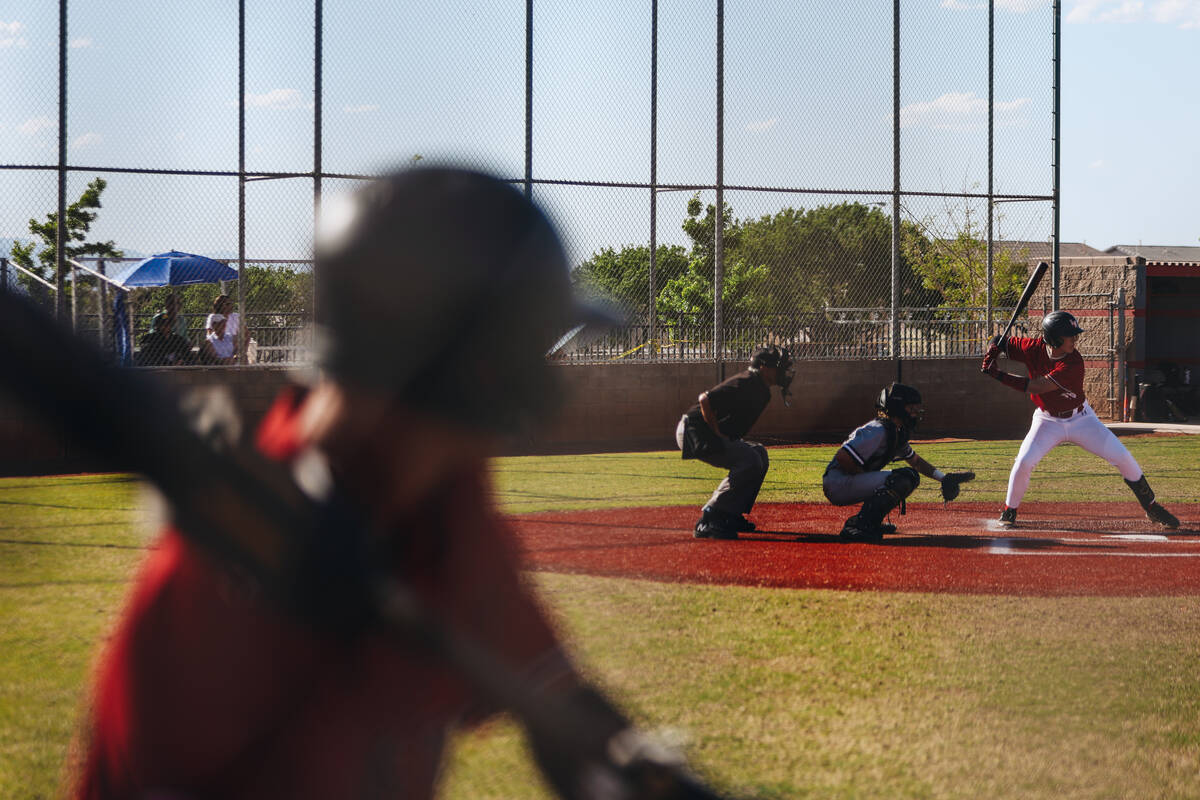 A Las Vegas player warms up as his teammate is up to bat during a baseball game between Faith L ...