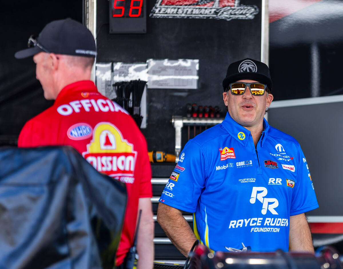 Top Fuel racer Tony Stewart laughs at a crew member in his pit before his first race of the day ...