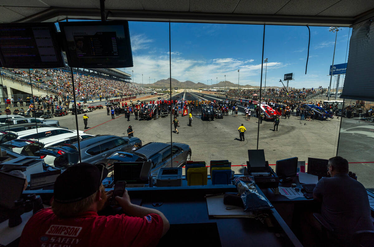 Funny Cars race down the track during Day 1 of NHRA 4-Wide Nationals on "The Strip" a ...