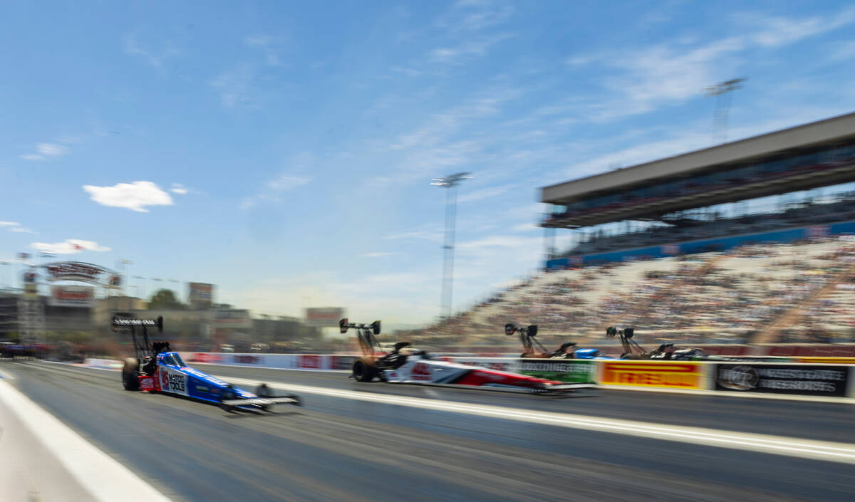 Top Fuel cars move down the track during Day 1 of NHRA 4-Wide Nationals on "The Strip&quot ...