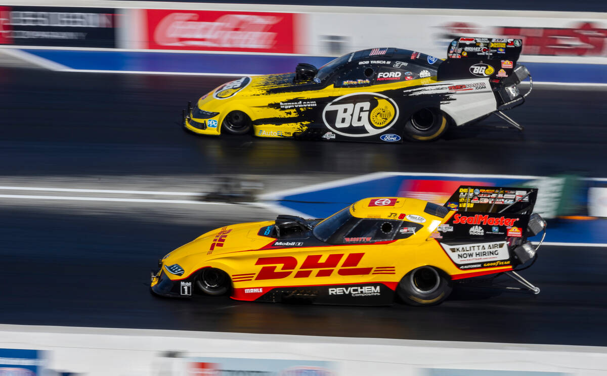 Funny Car driver Bob Tasca III, top, pulls away from Chad Mixon during Day 1 of NHRA 4-Wide Nat ...