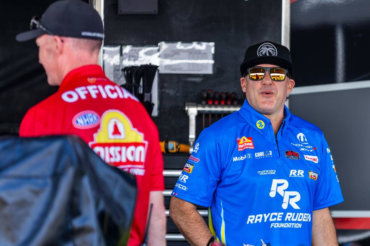 Top Fuel racer Tony Stewart laughs at a crew member in his pit before his first race of the day ...