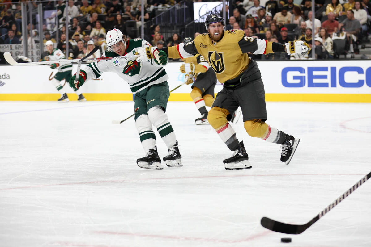 Golden Knights right wing Anthony Mantha (39) defends against Wild center Joel Eriksson Ek (14) ...