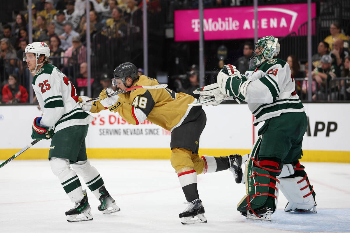 Wild goaltender Marc-Andre Fleury (29) pushes Golden Knights center Tomas Hertl (48) away while ...