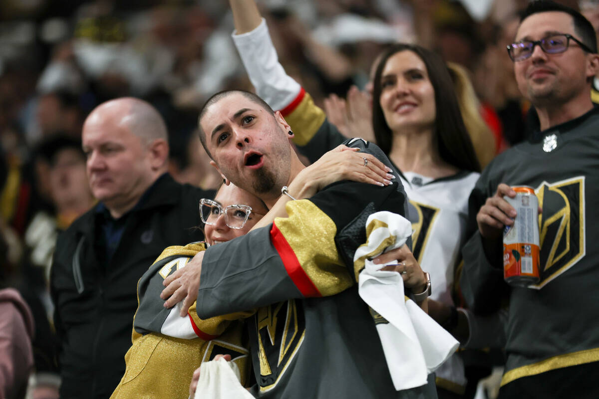 Golden Knights fans celebrate a goal during the second period of an NHL hockey game against the ...