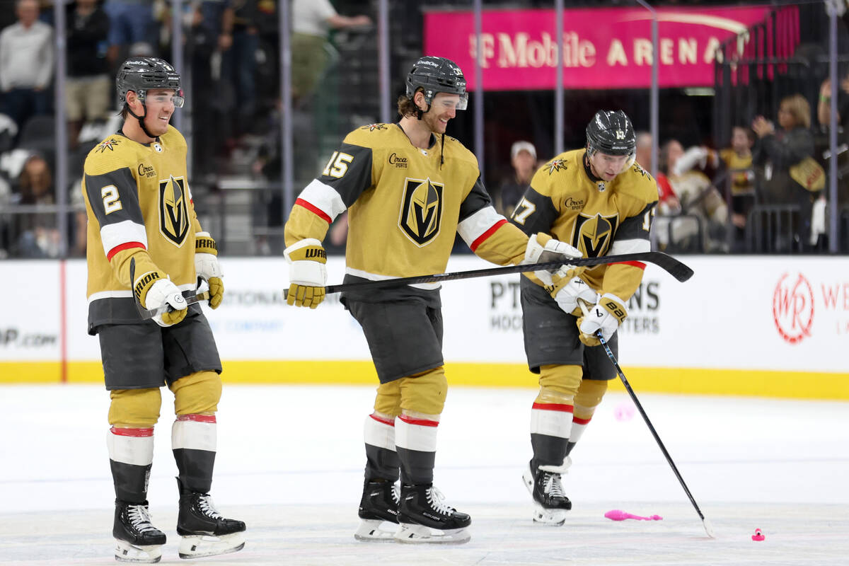 Golden Knights defenseman Zach Whitecloud (2), defenseman Noah Hanifin (15) and defenseman Ben ...