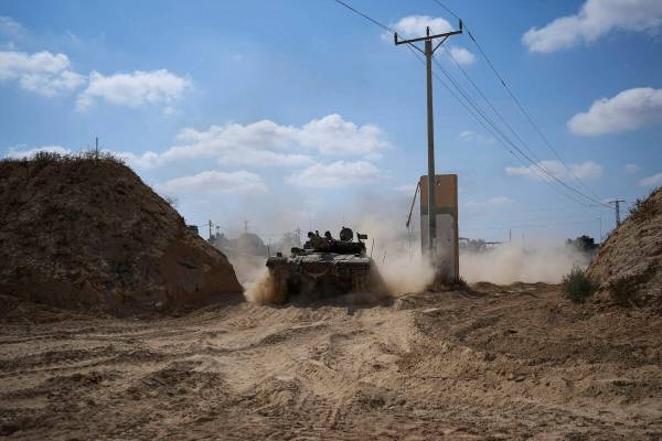 An Israeli tank moves near the Gaza Strip border in southern Israel, Thursday, April 11, 2024. ...