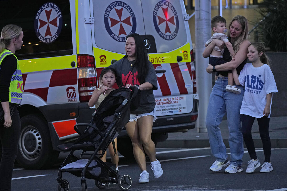 People are led out from the Westfield Shopping Centre where multiple people were stabbed in Syd ...