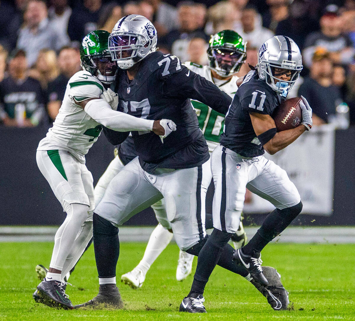 Raiders wide receiver Tre Tucker (11) breaks free for a first down with a block by offensive ta ...