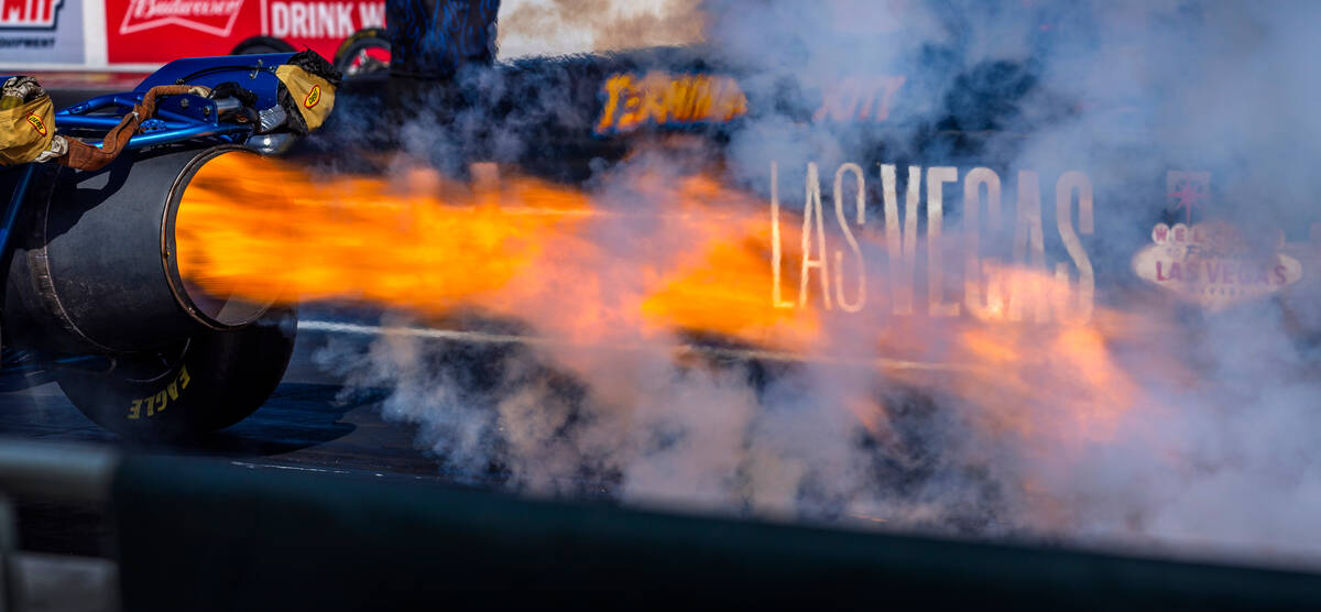 Flames blast out of the MavTV Plus Missile rocket dragster driven by Jaren Mott during Day 2 of ...