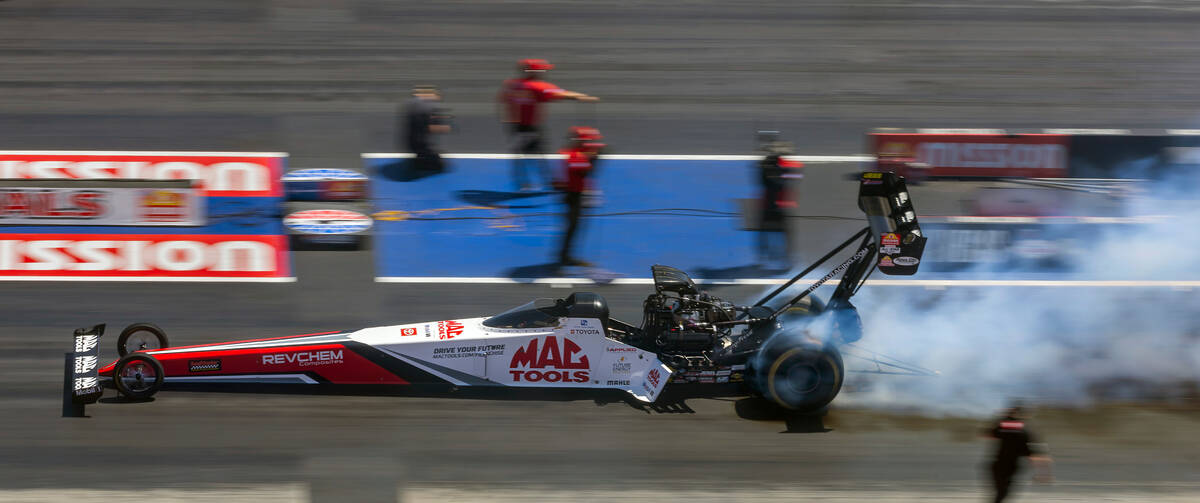 Top Fuel driver Doug Kalitta does a burnout to to warm up his tires during Day 2 of NHRA 4-Wide ...