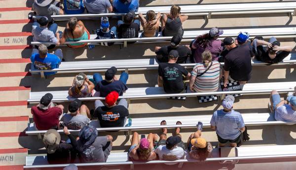 Fans sit on Las Vegas racing mats in the stands during Day 2 of NHRA 4-Wide Nationals on " ...