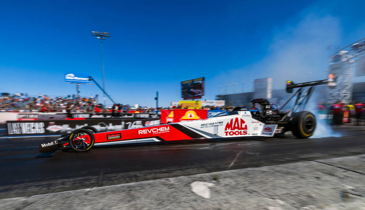 Top Fuel driver Doug Kalitta does a burnout to warm his tires during Day 2 of NHRA 4-Wide Natio ...
