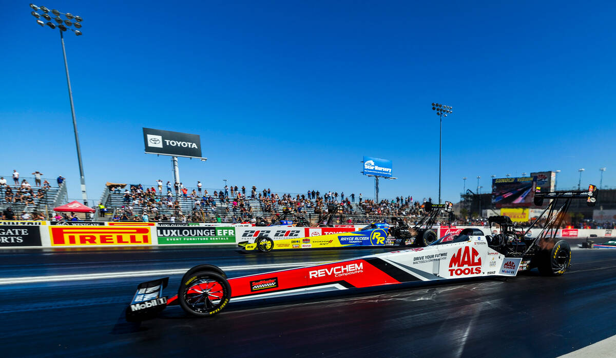 Top Fuel driver Doug Kalitta, front, leads Tony Stewart early in their race during Day 2 of NHR ...