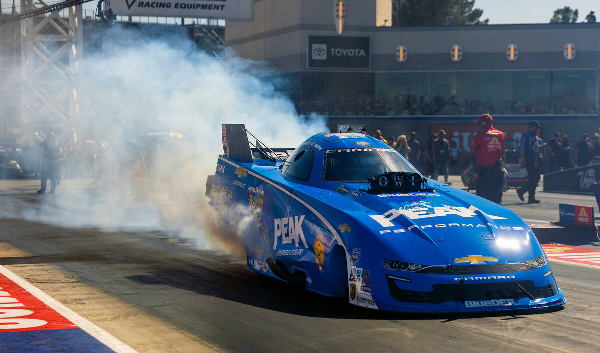 Funny Car driver John Force does a burnout to warm his tires during Day 2 of NHRA 4-Wide Nation ...