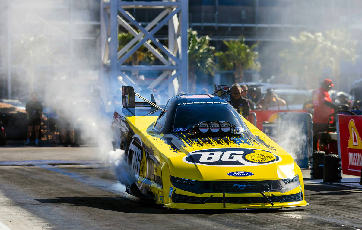 Funny Car driver Bob Tasca III does a burnout to warm his tires during Day 2 of NHRA 4-Wide Nat ...