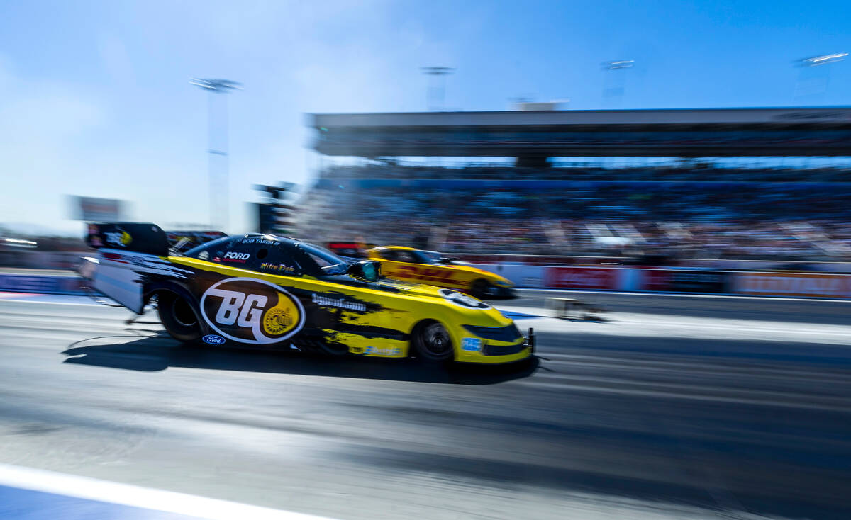 Funny Car driver Bob Tasca III, near, races beside J.R. Todd during Day 2 of NHRA 4-Wide Nation ...