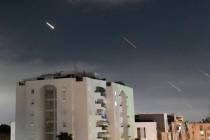 Israeli Iron Dome air defense system launches to intercept missiles fired from Iran, in central ...