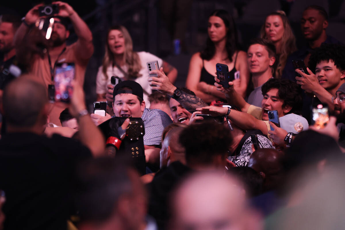 Fans go wild while Alex Pereira leaves the arena after defeating Jamahal Hill in the first roun ...