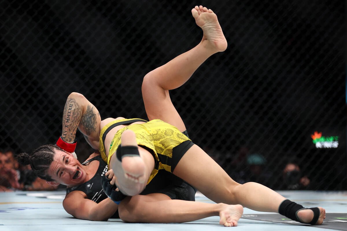 Marina Rodriguez struggles under Jessica Andrade during a UFC 300 mixed martial arts women&#x20 ...