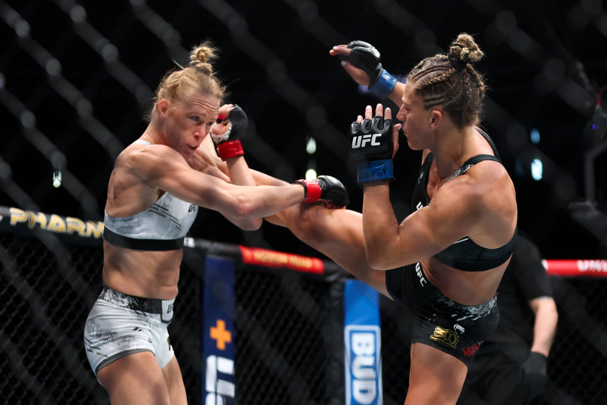 Kayla Harrison gets a kick on Holly Holm during a UFC 300 mixed martial arts women’s ban ...