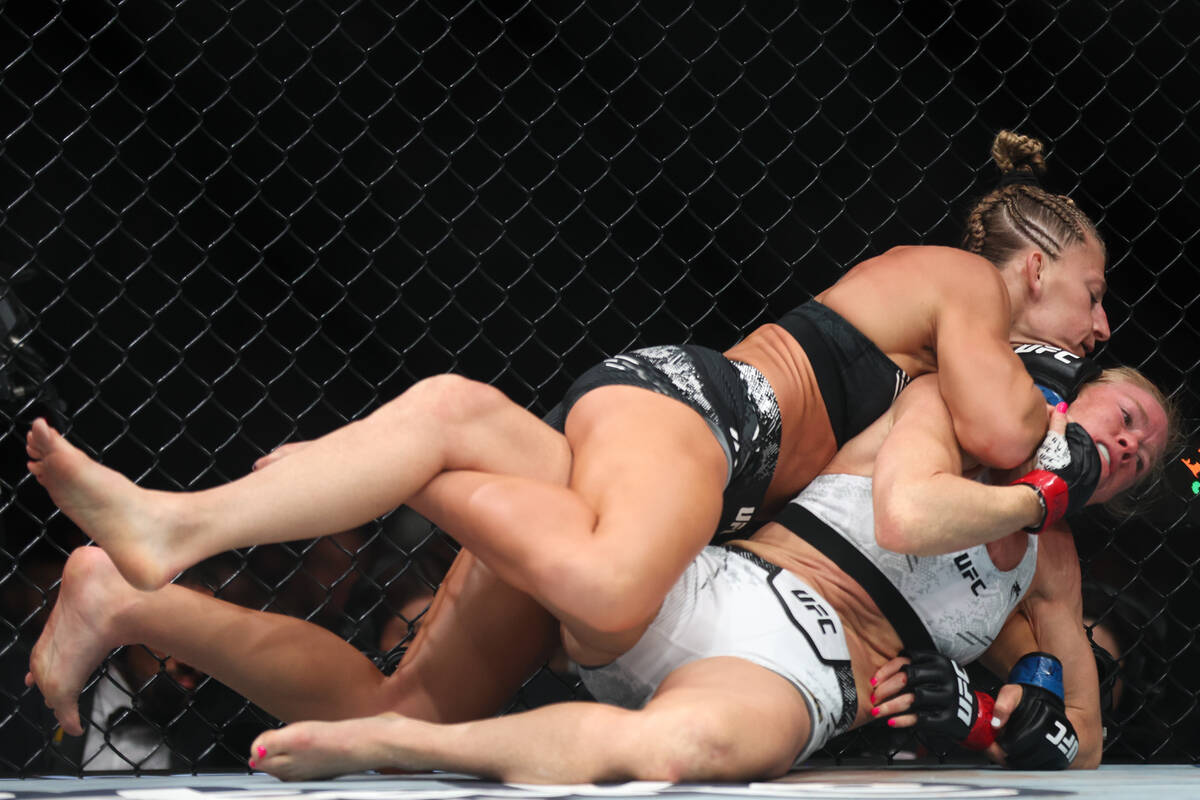 Kayla Harrison takes Holly Holm to the mat during a UFC 300 mixed martial arts women’s b ...