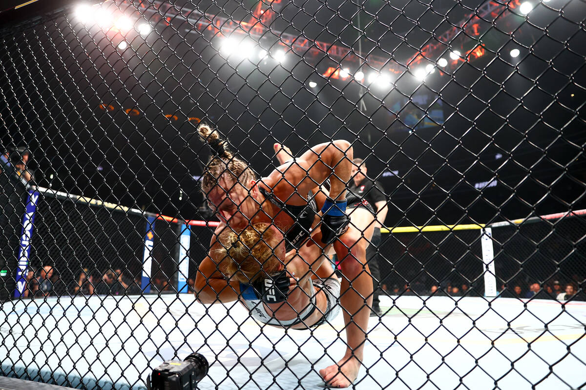 Kayla Harrison slams down Holly Holm during a UFC 300 mixed martial arts women’s bantamw ...