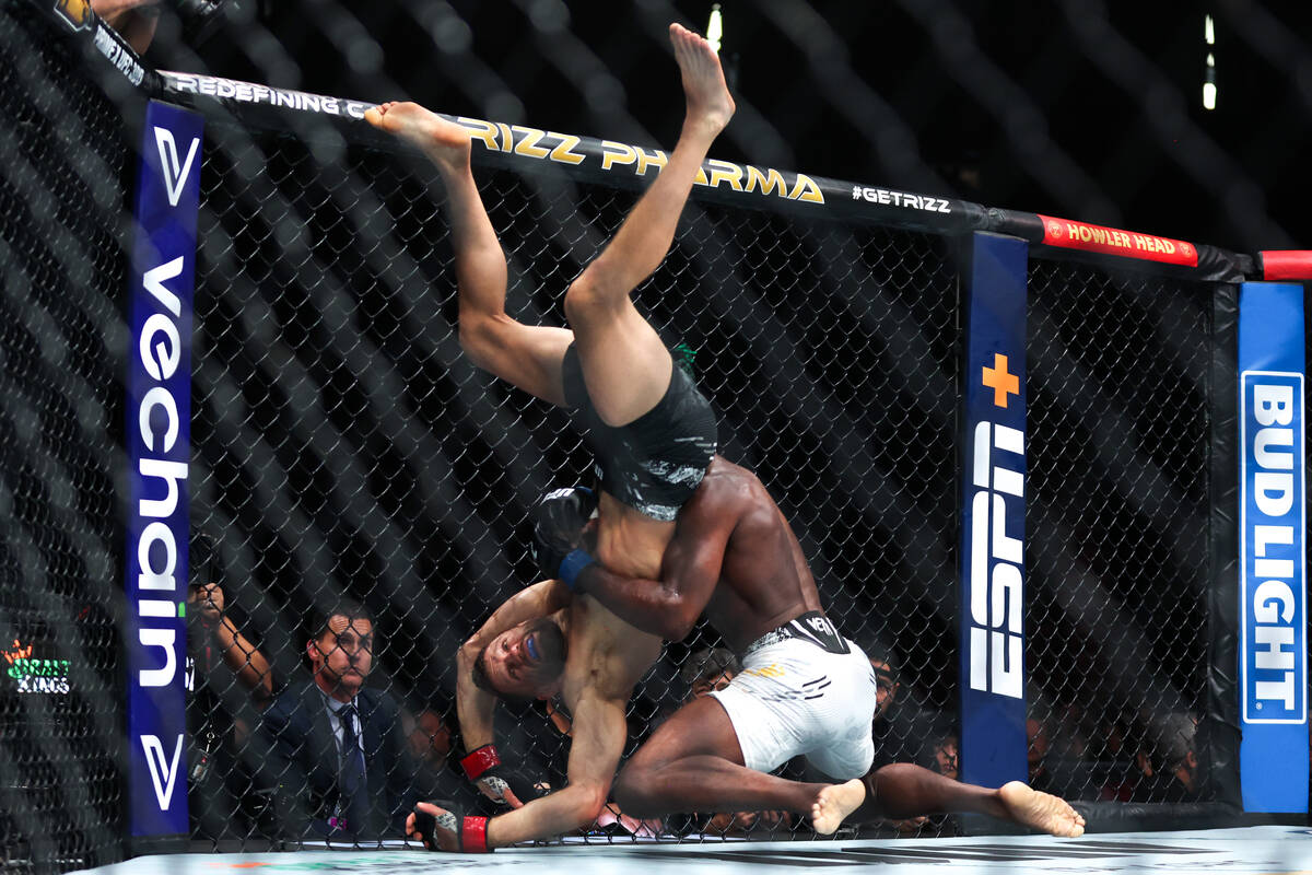 Aljamain Sterling upends Calvin Kattar during a UFC 300 mixed martial arts featherweight bout a ...