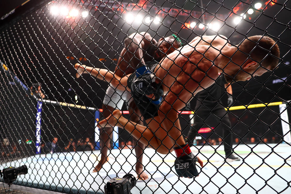 Aljamain Sterling throws Calvin Kattar into the cage during a UFC 300 mixed martial arts feathe ...