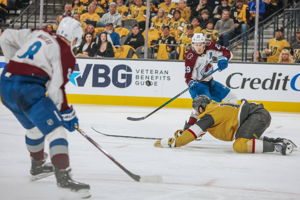 Colorado Avalanche center Nathan MacKinnon (29) races toward the puck during an NHL hockey game ...