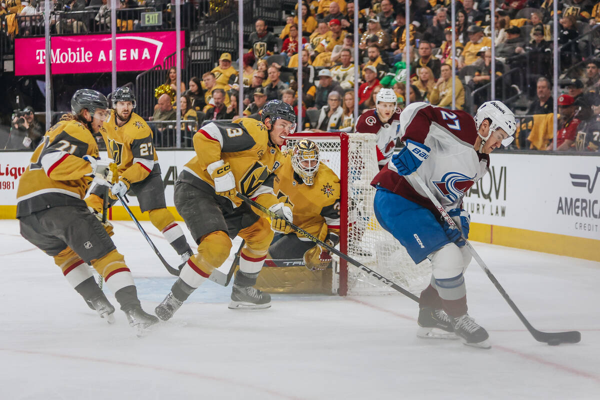 Colorado Avalanche left wing Jonathan Drouin (27) races the puck away from a group of Golden Kn ...