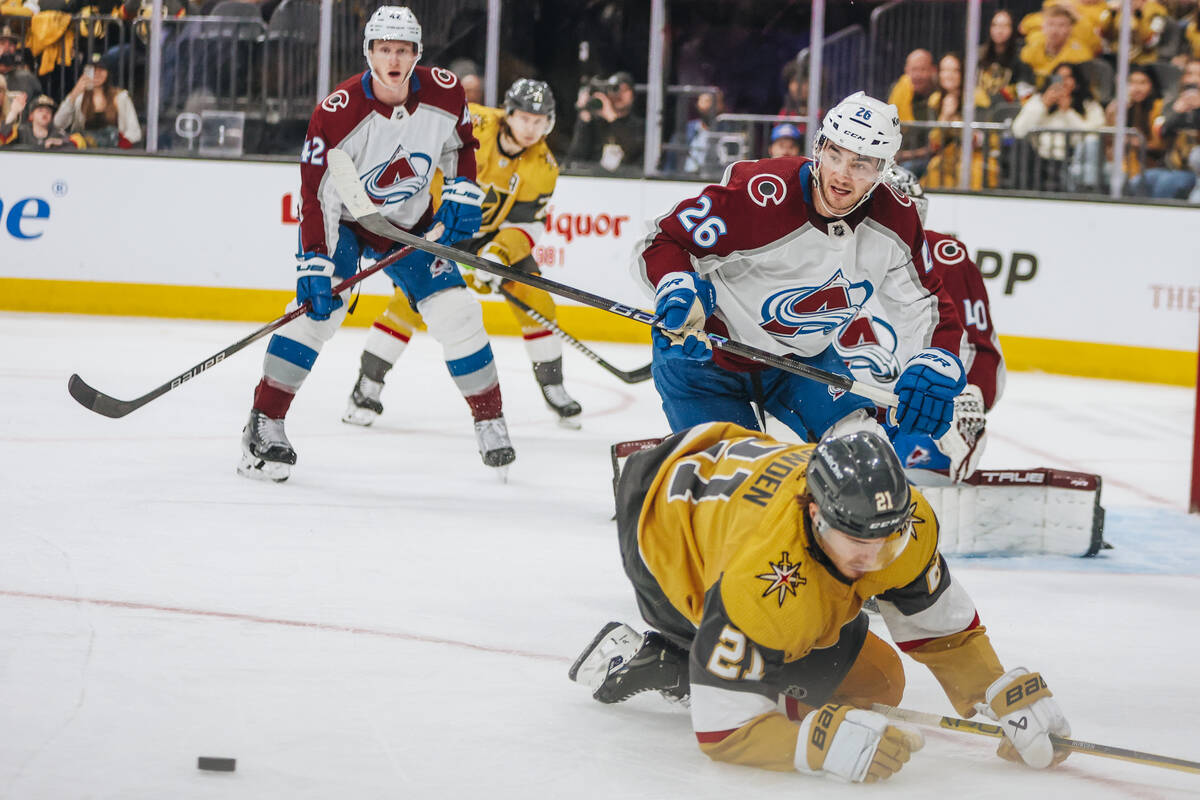 Golden Knights center Brett Howden (21) loses his balance as Colorado Avalanche defenseman Sean ...