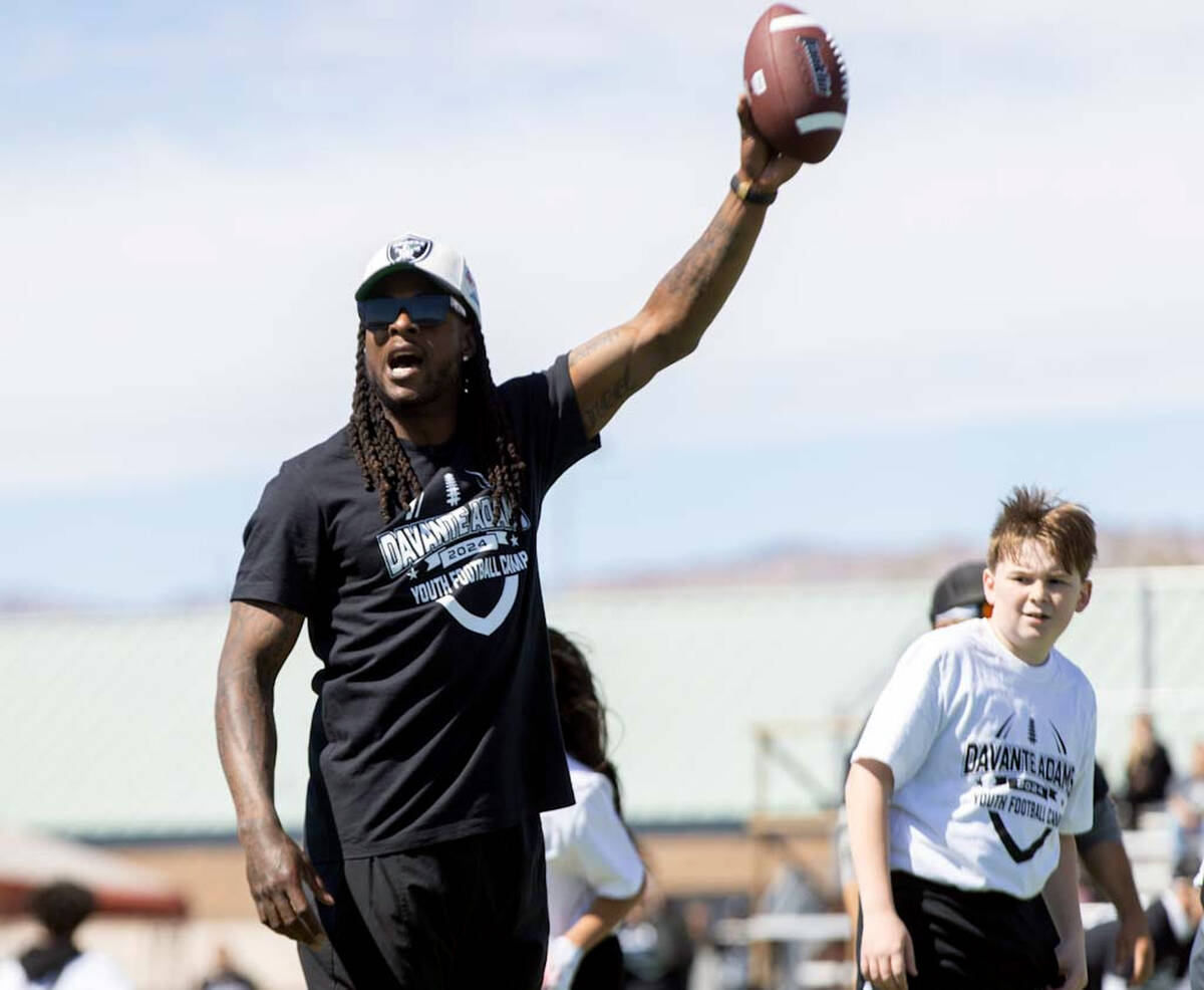 Raiders wide receiver Davante Adams runs drills with participants of his youth camp on Sunday, ...