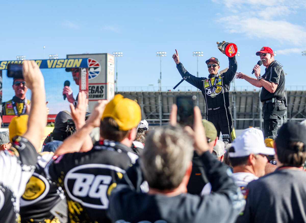 Funny car driver Bob Tasca cheers to the audience after winning the NHRA 4-Wide Nationals at th ...