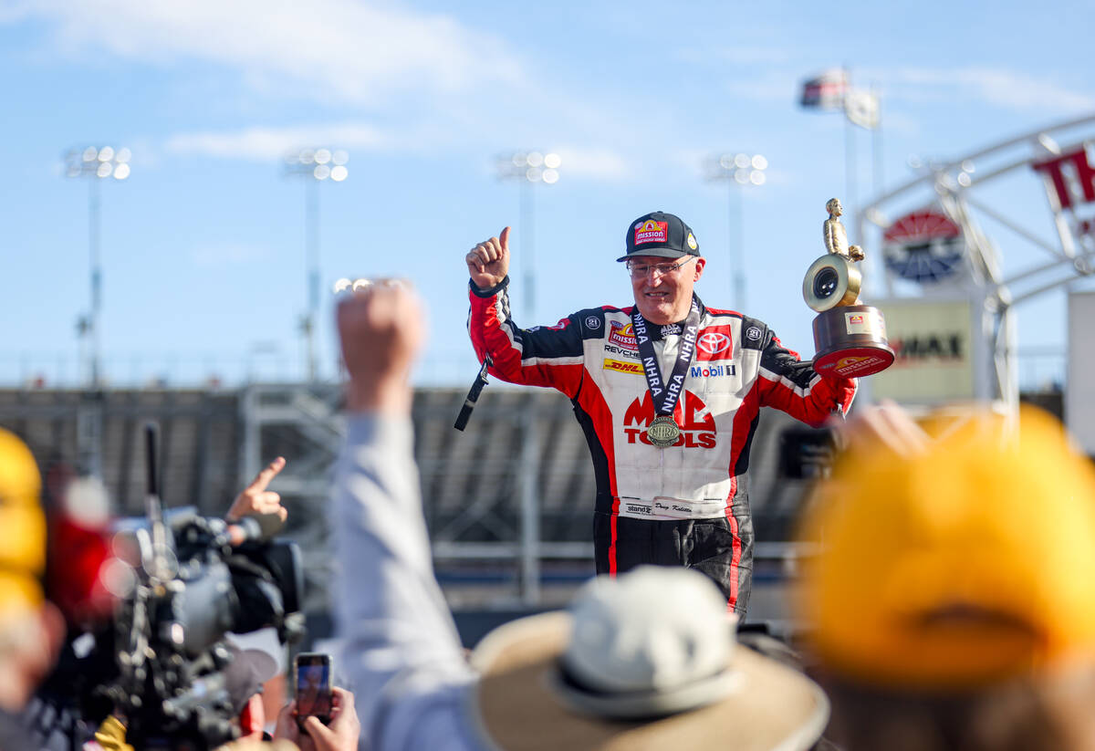 Top fuel driver Doug Kalitta cheers to the audience after winning the NHRA 4-Wide Nationals at ...