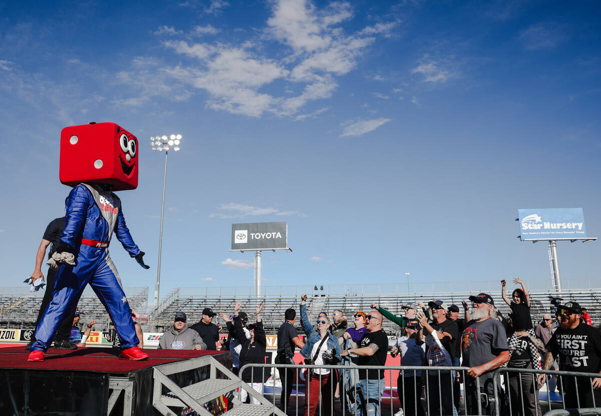 Mascot for the Las Vegas Motor Speedway Pit Boss rallies the crowd before he throws a free shir ...
