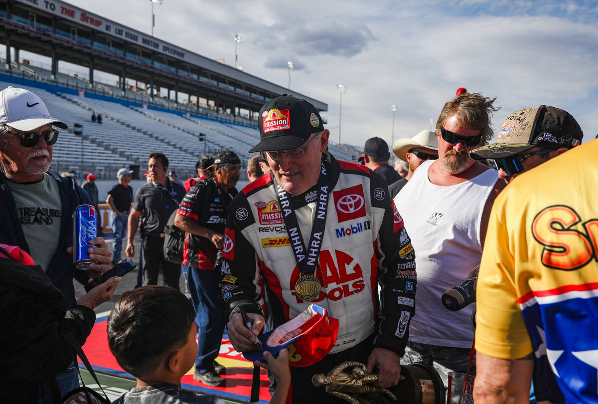 Top fuel driver Doug Kalitta signs autographs for fans following his win in the NHRA 4-Wide Nat ...