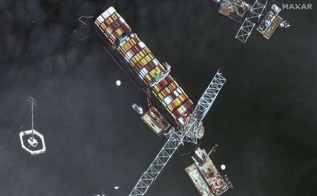 FILE - This satellite image provided by Maxar shows the bow of the container ship Dali remains ...