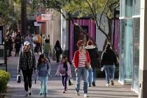 Shoppers walk through Downtown Summerlin in Las Vegas on Black Friday, Nov. 24, 2023. (K.M. Can ...