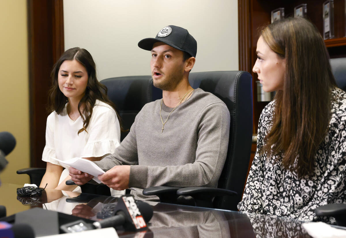 Bryce Page, center, the brother of a shooting victim Ashley Prince, reads a statement at the pr ...