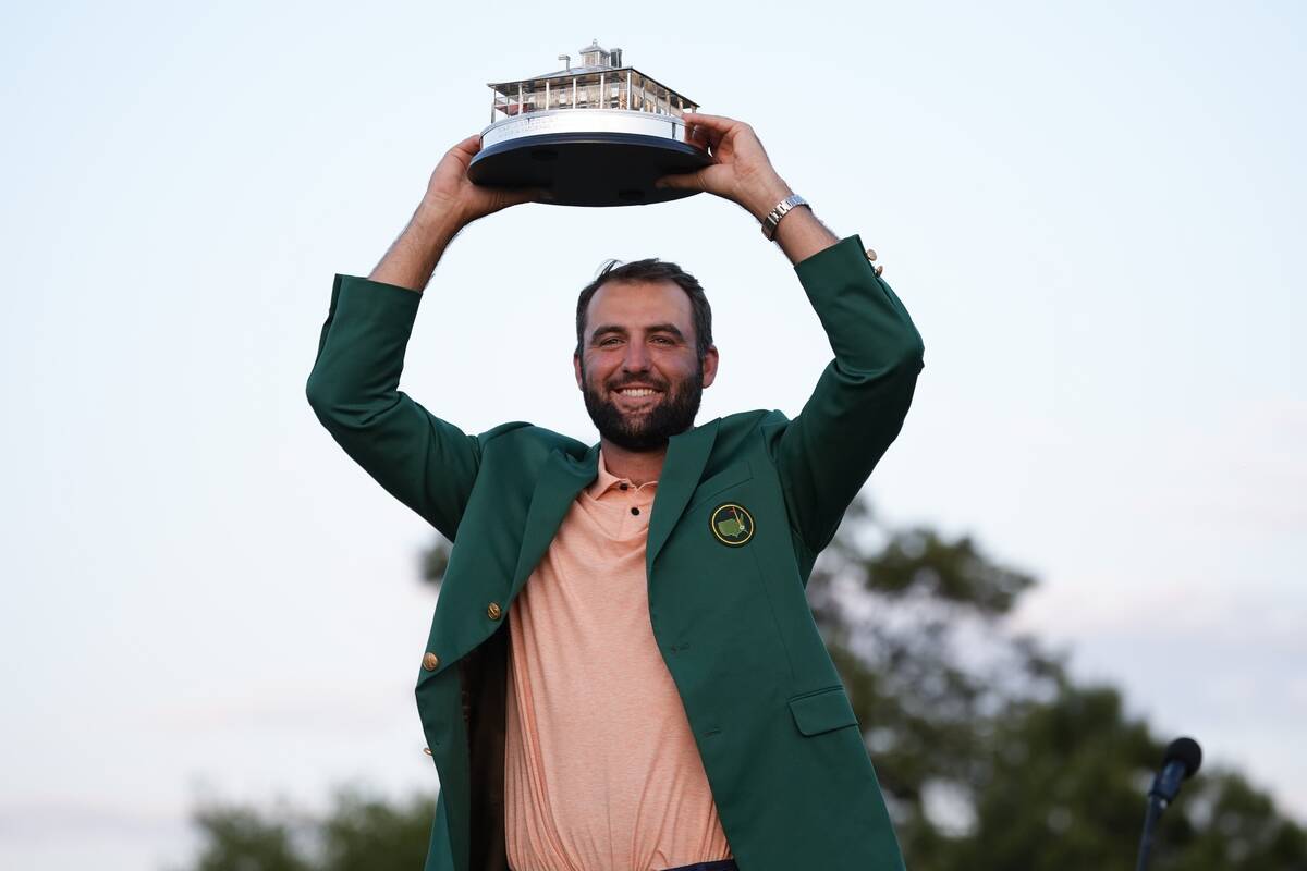 Scottie Scheffler holds the trophy after winning the Masters golf tournament at Augusta Nationa ...