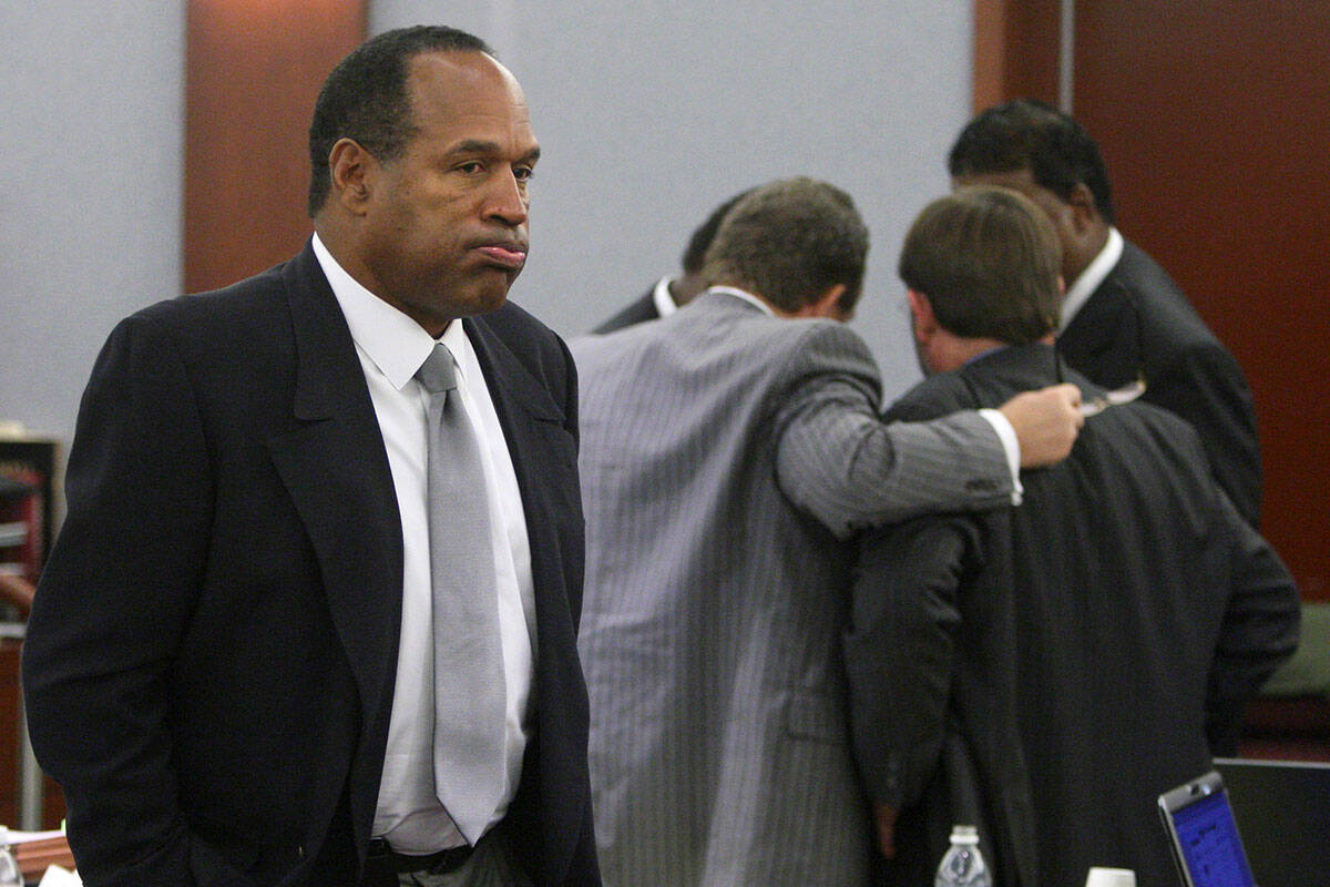 Simpson appears during his trial as co-defendant Clarence "C.J." Stewart confers with his attor ...