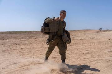An Israeli soldier walks near the Israeli-Gaza border, in southern Israel, Monday, April 15, 20 ...
