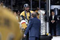 Golden Knights captain Mark Stone accepts the Stanley Cup from NHL commissioner Gary Bettman af ...