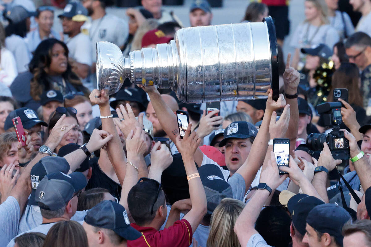 A Golden Knights player holds up the Stanley Cup at the team's Stanley Cup victory parade, Satu ...