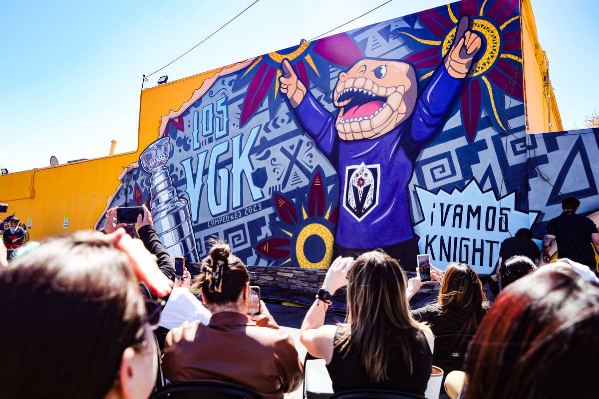 Guests take photos of the unveiled Golden Knights mural on the side of Casa Don Juan in the Art ...